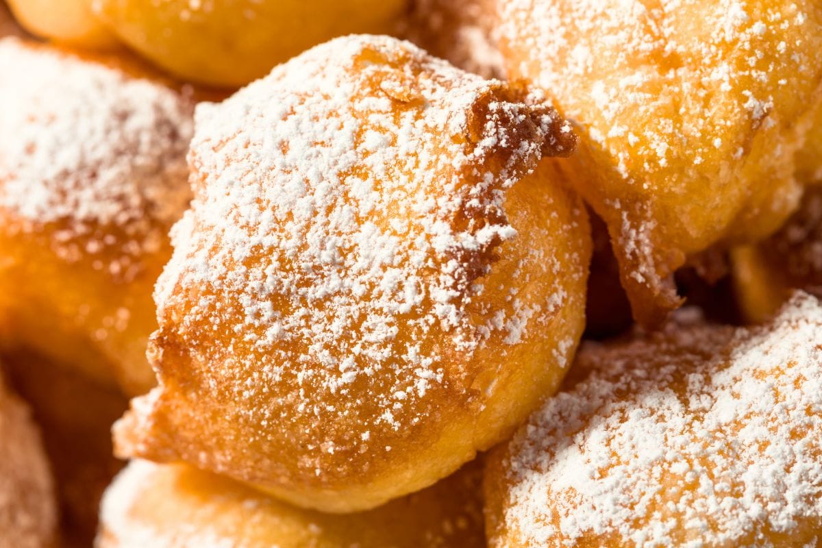 Homemade zeppole dough balls frying in hot oil