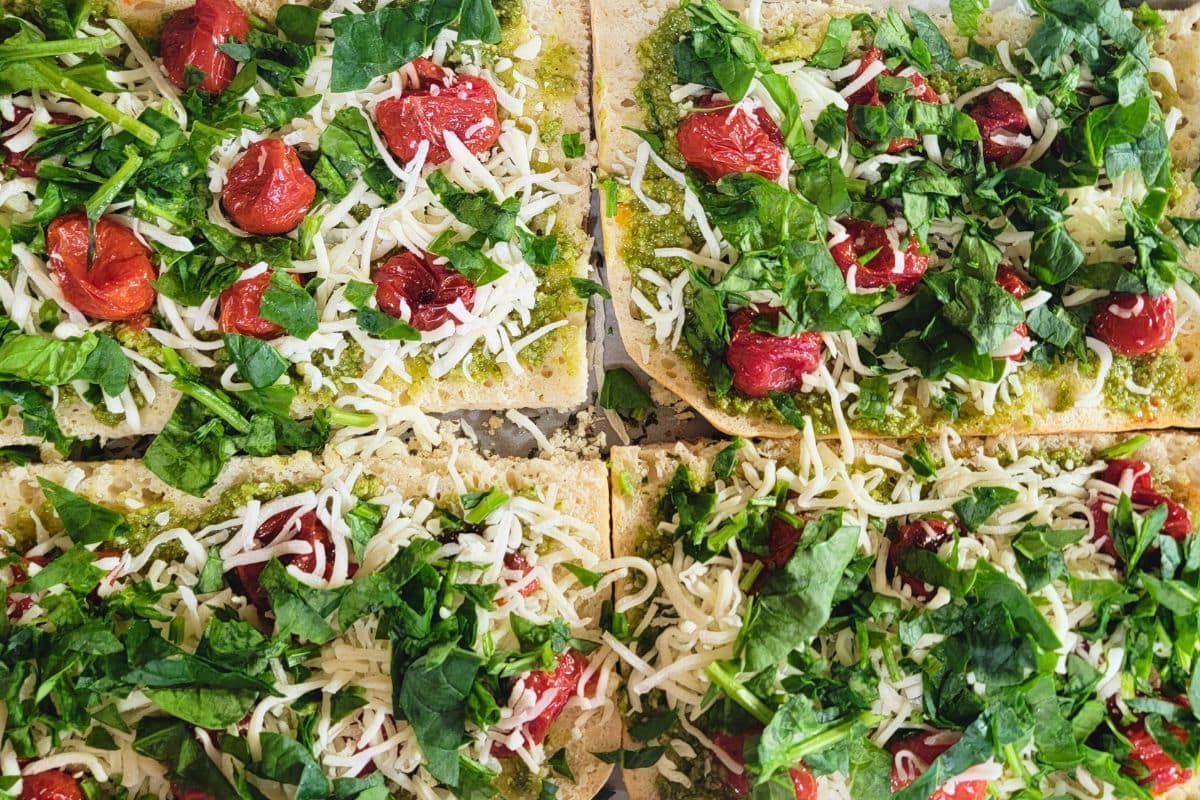 easy roasted tomatoes, spinach, basil pesto on top